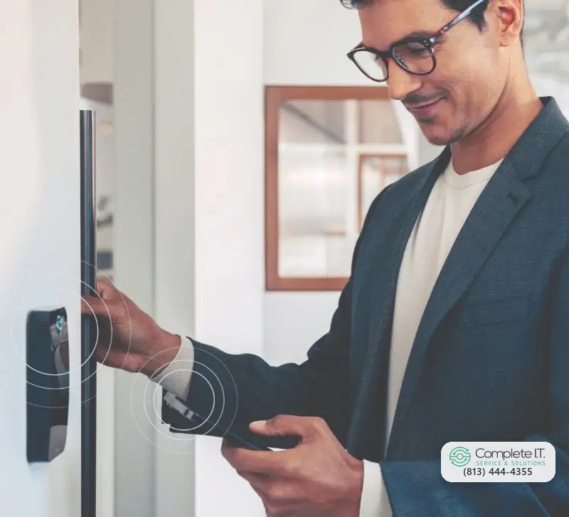 Man opening a door with his phone at a Brivo access reader
