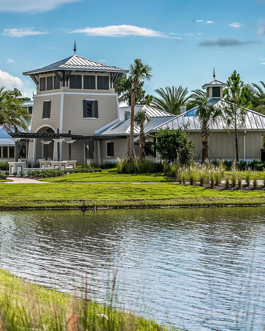 Florida community clubhouse on a lake with palm trees